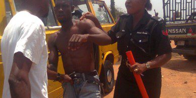 Agbero (tout) captured by the Nigerian police.