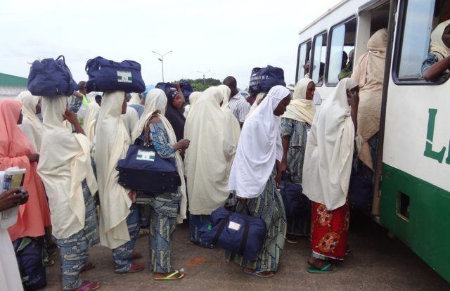Nigerian pilgrims get on a bus as they leave the Mallam Aminu Kano International Airport shortly after their arrival from the muslim holy city of Madina, on September 26, 2012, in Kano. Saudi Arabia has denied entry to some 1,000 Nigerian woman seeking to visit for Hajj because they were not accompanied by men, with most stuck at the Jeddah airport, Nigerian officials said on September 26. About 171 of the women returned home to Nigeria on a flight the same day, an official said. AFP PHOTO / Aminu ABUBAKARAMINU ABUBAKAR/AFP/GettyImages ** TCN OUT **