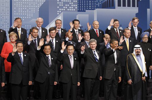 World leaders wave during a group photo at the G20 Summit in Toronto, Sunday, June 27, 2010.