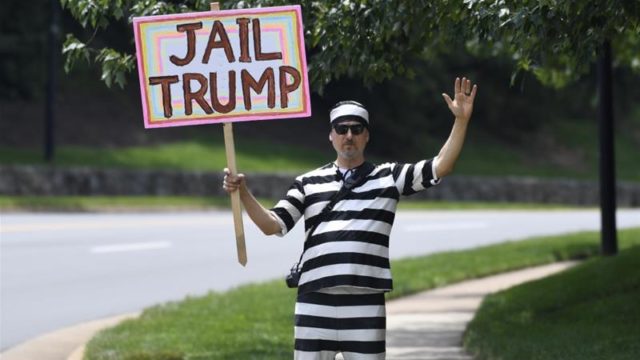 A protesters stands outside the Trump National Golf Club in Sterling, Virginia, as he waits for President Trump to depart on June 16, 2019 [AP/Susan Walsh] [Daylife]