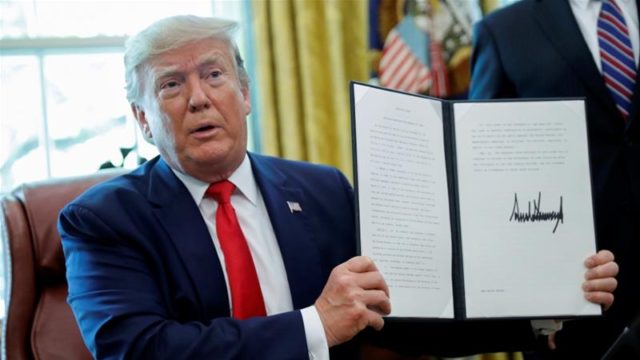 US President Donald Trump displays an executive order imposing fresh sanctions on Iran in the Oval Office of the White House in Washington US June 24 2019