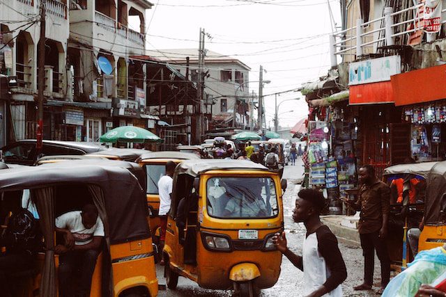 Lagos car and molue bus with Keke