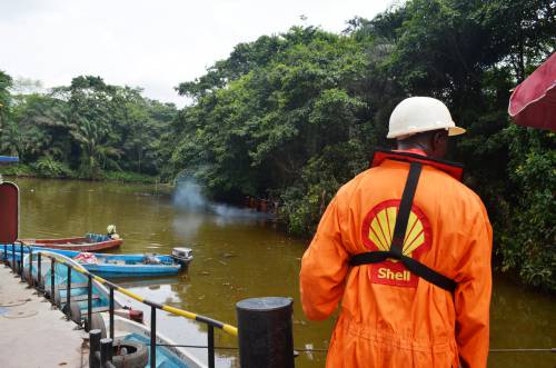 oil worker examining environmental damage at SEIBOU deep well