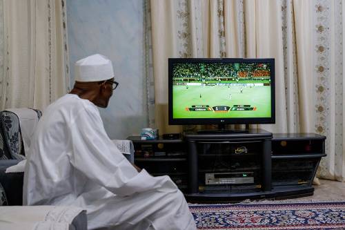 President Muhammadu Buhari watches the Nigeria Cameroon match