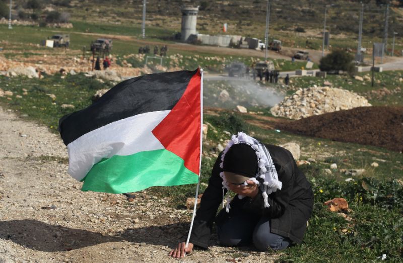Palestinian woman with flag