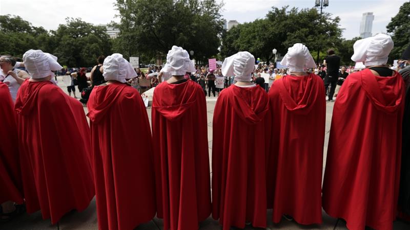 The Texas Handmaids activist group joins a protest against abortion restrictions at the State Capitol in Austin