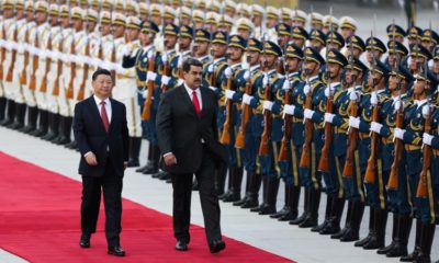 Chinese President Xi Jinping walks next to Venezuelas President Nicolas Maduro during his welcoming ceremony in Beijing
