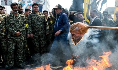 Iranians burn a mask of Donald Trump during a protest marking the annual al Quds Day Jerusalem Day in Tehran Iran