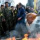 Iranians burn a mask of Donald Trump during a protest marking the annual al Quds Day Jerusalem Day in Tehran Iran