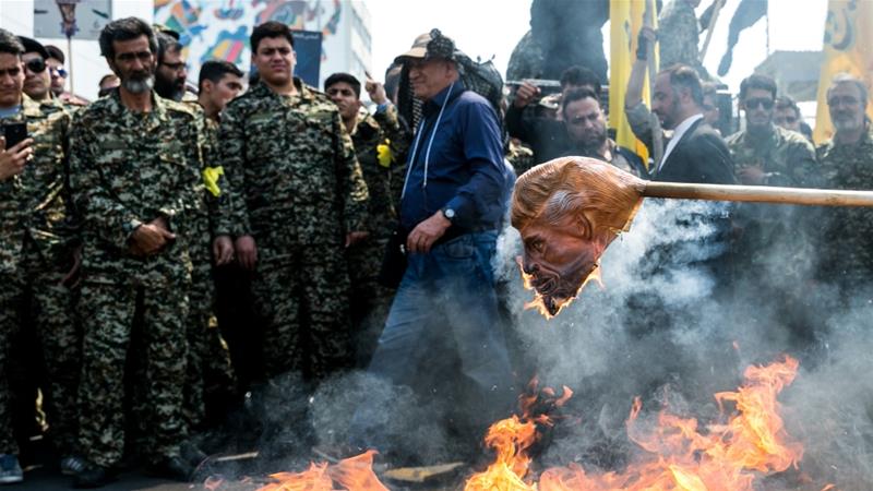 Iranians burn a mask of Donald Trump during a protest marking the annual al Quds Day Jerusalem Day in Tehran Iran