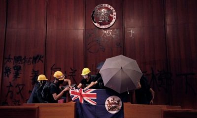 cropped Protesters are seen in Hong Kongs Legislative Council building during the anniversary of Hong Kongs handover to China on July 1 2019. The banner reads There are no thugs only tyranny