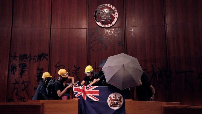 cropped Protesters are seen in Hong Kongs Legislative Council building during the anniversary of Hong Kongs handover to China on July 1 2019. The banner reads There are no thugs only tyranny