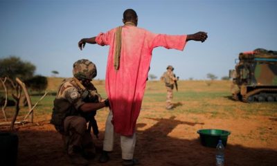 A French soldier searches a man during an area control operation in the Gourma region during Operation Barkhane in Ndaki