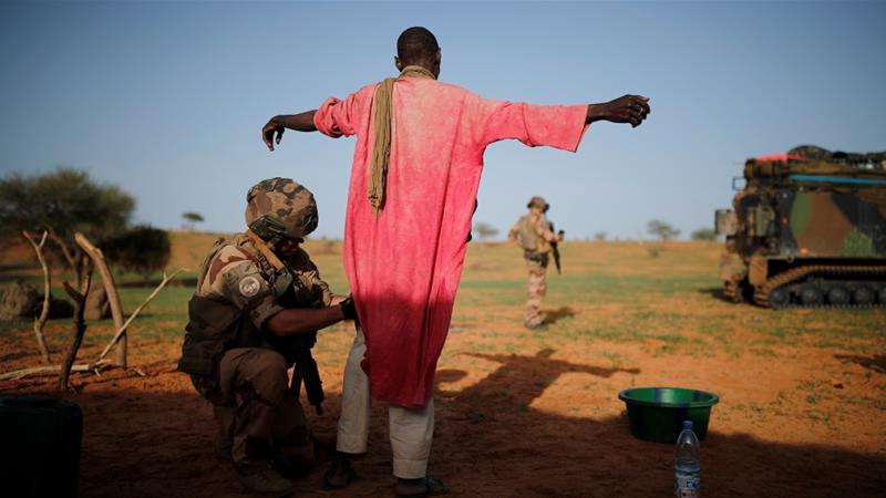A French soldier searches a man during an area control operation in the Gourma region during Operation Barkhane in Ndaki