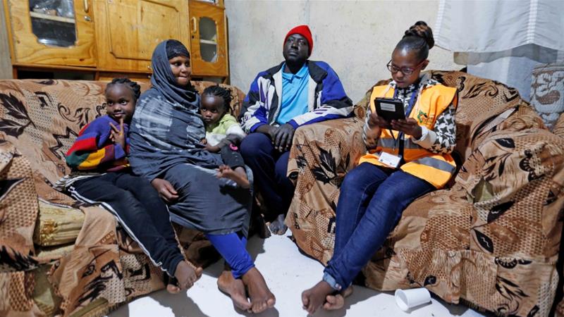 An enumerator records details of a family participating in the 2019 Kenya Population and Housing Census at the Kibera slum in Nairobi