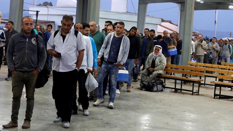 Palestinian workers wait to cross the Israeli controlled Al Jalama checkpoint as they head to work in Israel near Jenin in the Israeli occupied West Bank