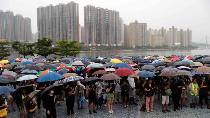 People stand during a protest in Hong Kong, China on August 25, 2019 [Reuters/Kai Pfaffenbach]