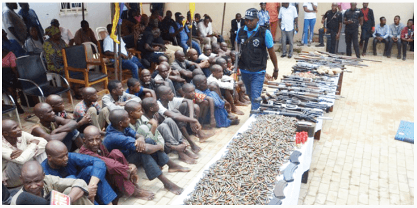 Suspected kidnappers armed robbers gun runners and dealers of illegal weapons from Libya and Chad being paraded by the Nigeria Police Force at the SARS office in Abuja