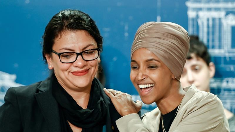 US Representatives Rashida Tlaib and Ilhan Omar react as they discuss travel restrictions to Palestine during a news conference in St Paul Minnesota