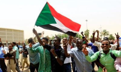 cropped Sudanese people chant slogans as they celebrate the signing of a constitutional declaration between TMC and FFC in Khartoum Sudan on