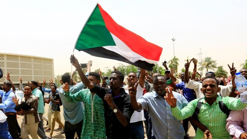 cropped Sudanese people chant slogans as they celebrate the signing of a constitutional declaration between TMC and FFC in Khartoum Sudan on