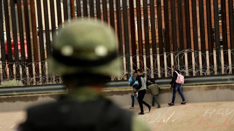 A National Guard soldier observes migrants who crossed illegally into El Paso, Texas to ask for asylum, as seen from Ciudad Juarez, Mexico September 15, 2019 [Jose Luis Gonzalez/Reuters]
