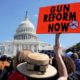 A protester holds up a sign during a demonstration calling for Congress to pass gun safety laws at the US Capitol in Washington