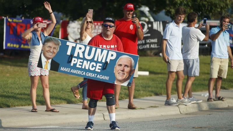 A supporter of President Donald Trump is seen from the media van in the presidential motorcade en route to a campaign rally in Greenville