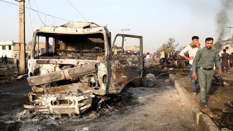 Afghan policemen inspect the site of a blast in Kabul Afghanistan