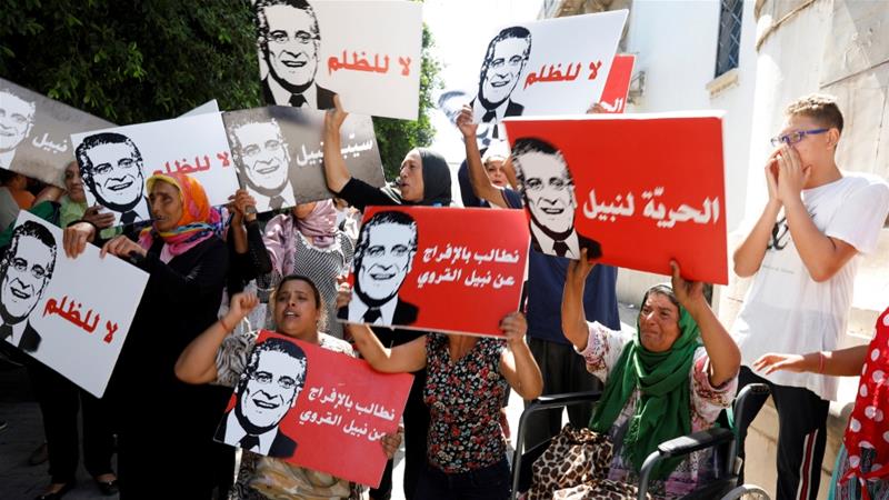 Supporters of presidential candidate Nabil Karoui take part in a rally in front of the courthouse asking for his release from prison in Tunis Tunisia