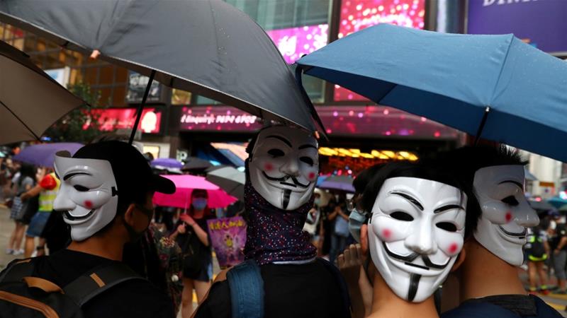 Anti government protesters wear masks during a demonstration at Causeway Bay district in Hong Kong China