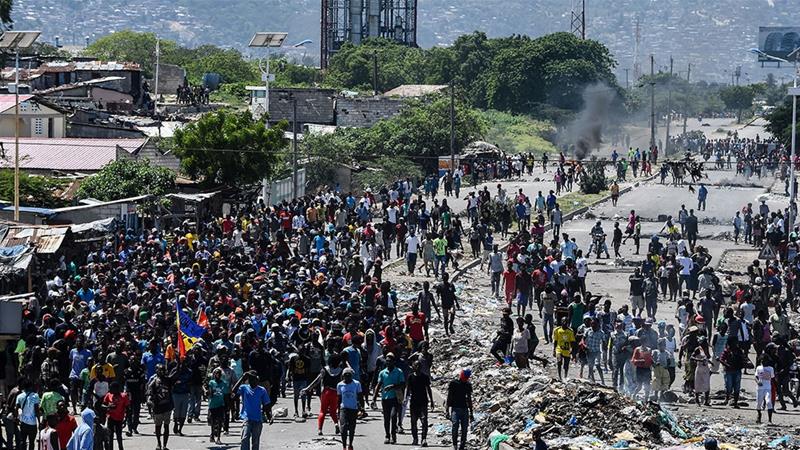 People march in Cite Soleil area of Port au Prince Haiti during a protest to demand the resignation of President Jovenel Moise