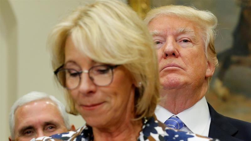 US President Trump and Vice President Pence wait as Education Secretary DeVos speaks to students at an event at the White House, May 3, 2017 [File: Jonathan Ernst/Reuters]
