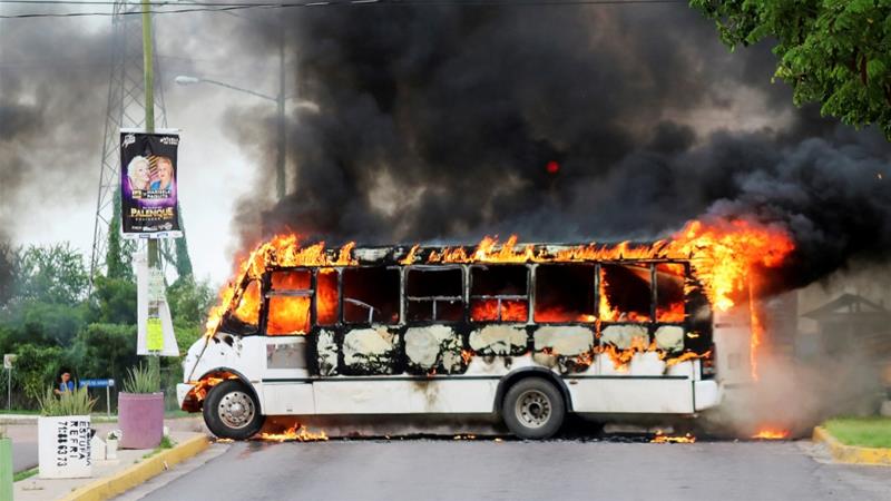 A burning bus is pictured during clashes between cartel gunmen and federal forces following the detention of Ovidio Guzman in Culiacan Sinaloa state Mexico