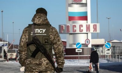 A member of the Ukrainian State Border Guard Service stands at the Goptovka crossing point on the border between Russia and Ukraine in Kharkiv Region Ukraine