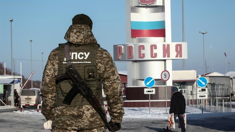 A member of the Ukrainian State Border Guard Service stands at the Goptovka crossing point on the border between Russia and Ukraine in Kharkiv Region Ukraine