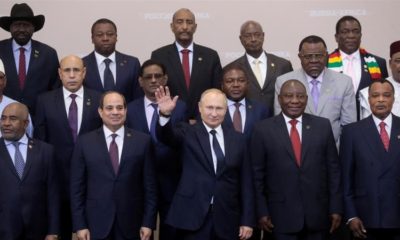 President Vladimir Putin waves during a family photo with heads of countries taking part in the 2019 Russia Africa Summit in Sochi