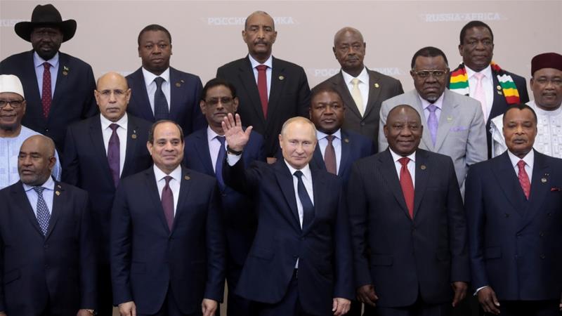 President Vladimir Putin waves during a family photo with heads of countries taking part in the 2019 Russia Africa Summit in Sochi
