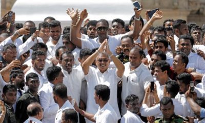 Sri Lankas President Gotabaya Rajapaksa waves at his supporters as he leaves after the presidential swearing in ceremony in Anuradhapura Sri Lanka