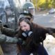 A demonstrator reacts as she is detained by riot policemen during a protest against Chiles government in Santiago Chile