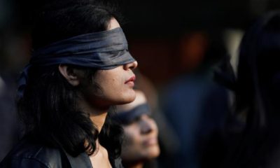 A protestor wearing a blindfold takes part in a protest in solidarity with rape victims and to oppose violence against women in India