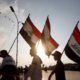 Demonstrators carry Iraqi flags during continuing anti government protests in Basra Iraq