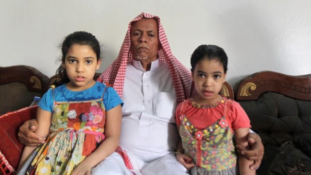 The orphaned daughters of Mohammed al Huraisi are seen with their grandfather Ali Abdullah al Huraisi at their home on the outskirts of Riyadh on May 22 2013