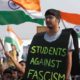 A man attends a protest against attacks on the students of New Delhis JNU on the outskirts of Mumbai on January 9 2020