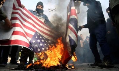 Demonstrators burn American and British flags during a protest against the assassination of the Iranian Major General Qassem Soleimani in Tehran on January 3 2020