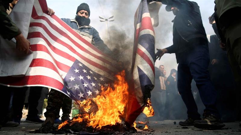 Demonstrators burn American and British flags during a protest against the assassination of the Iranian Major General Qassem Soleimani in Tehran on January 3 2020