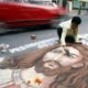 Indian painter Swapan Das gives finishing touches to a portrait of Jesus Christ on a busy road in the eastern Indian city of Kolkata on December 24 2008
