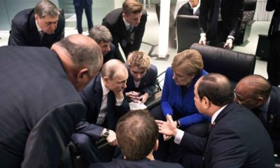 Russian President Vladimir Putin German Chancellor Angela Merkel and other officials talk during a conference on Libya at the German Chancellery in Berlin on January 19 2020