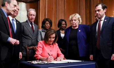 US House Speaker Nancy Pelosi signs the two articles of impeachment of US President Donald Trump before sending them over to the Senate on January 15 2020