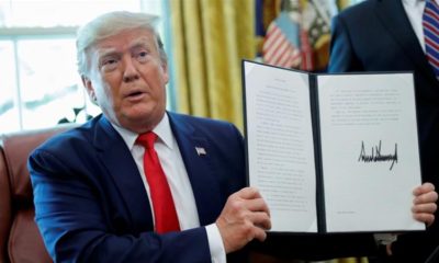 US President Donald Trump displays an executive order imposing fresh sanctions on Iran in the Oval Office of the White House in Washington US June 24 2019